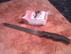 Packet of Halloumi Cheese, opened, with knife