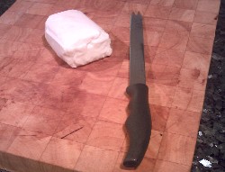 Slicing Halloumi cheese on a chopping board